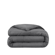 Folded gray comforter on a white background