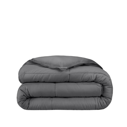 Folded gray comforter on a white background
