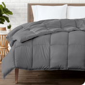 A modern bedroom with a duvet insert on a bed folded back over itself