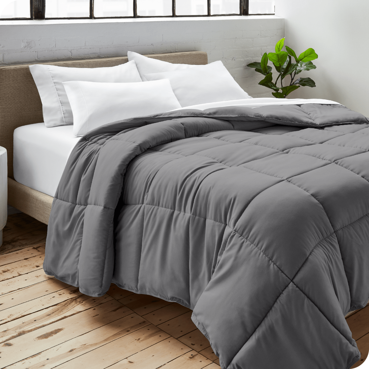 A bedroom with a duvet insert, pillowcases and shams on the bed