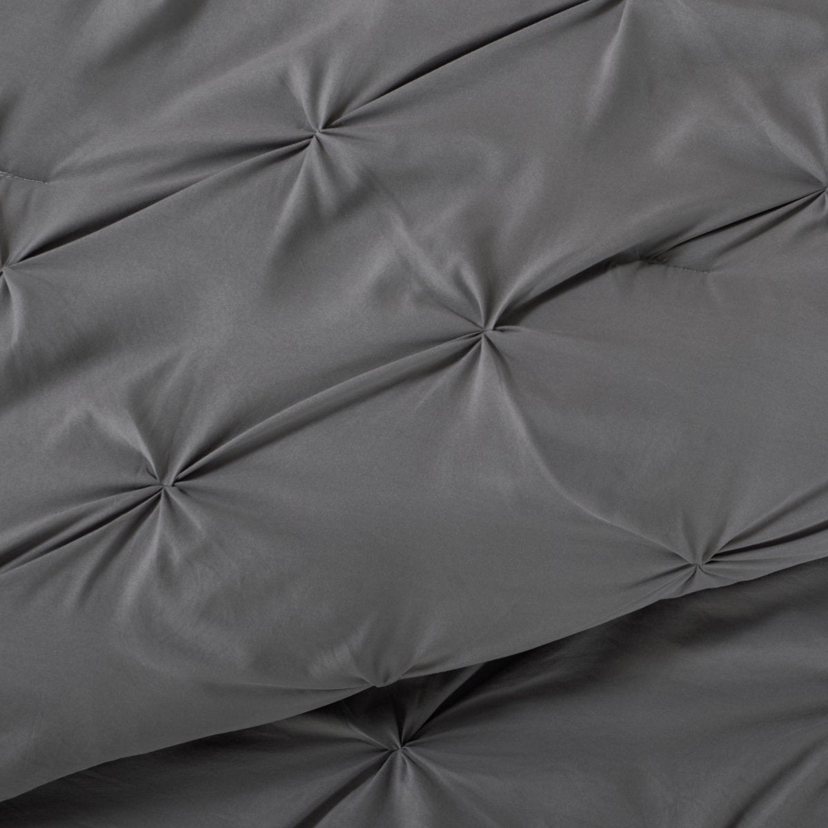 Close-up showing the pintuck detailing of the comforter set