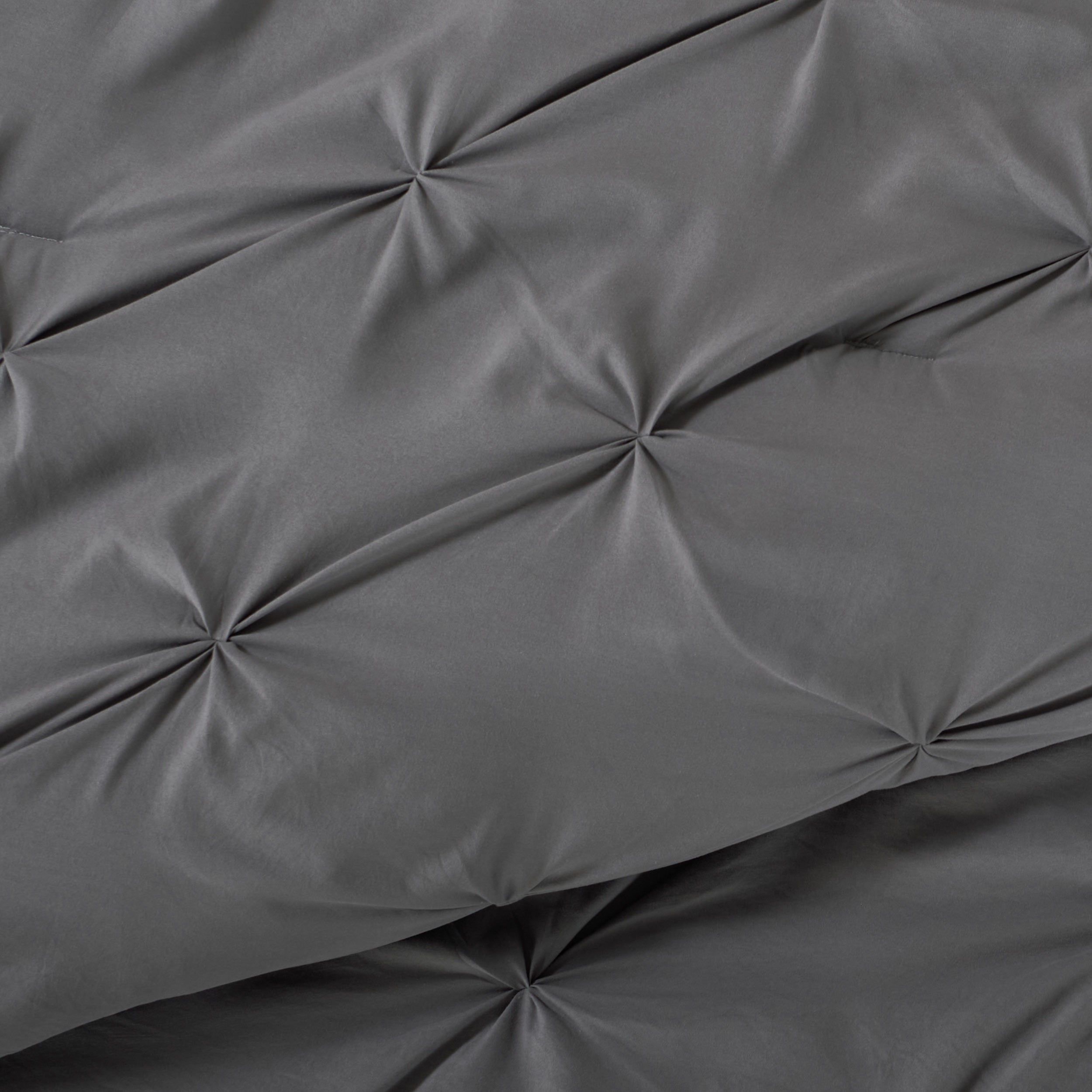 Close-up showing the pintuck detailing of the comforter set