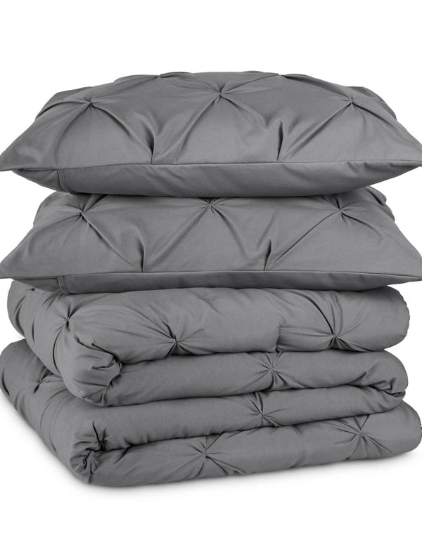 Grey pintuck comforter set folded and stacked