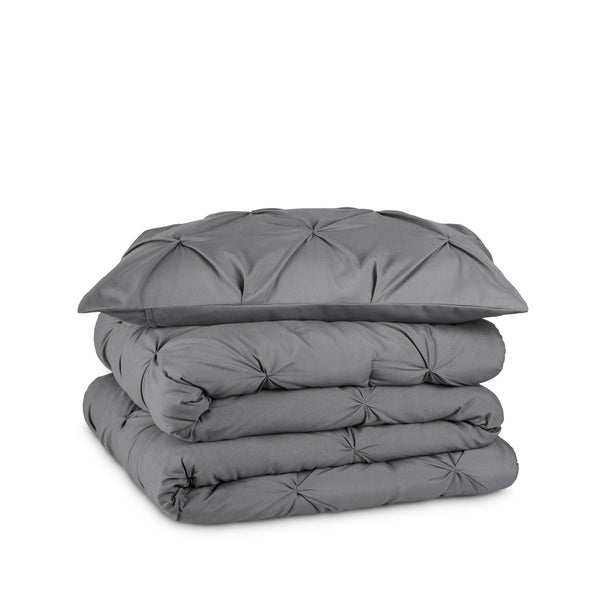 Gray pintuck comforter on a white background