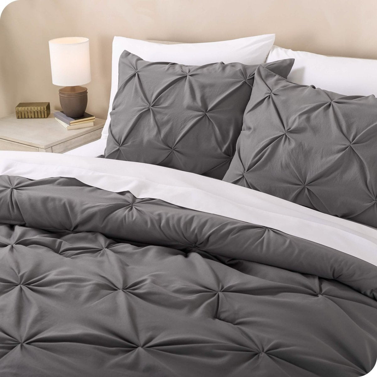 Close up of matching pillow shams and comforter with white sheets on the bed