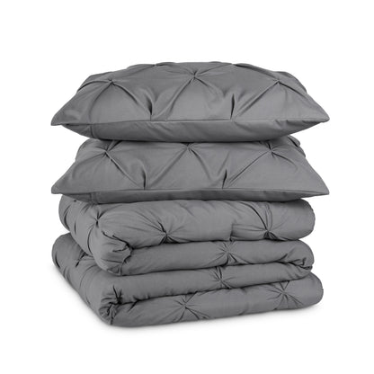Gray pintuck comforter on a white background