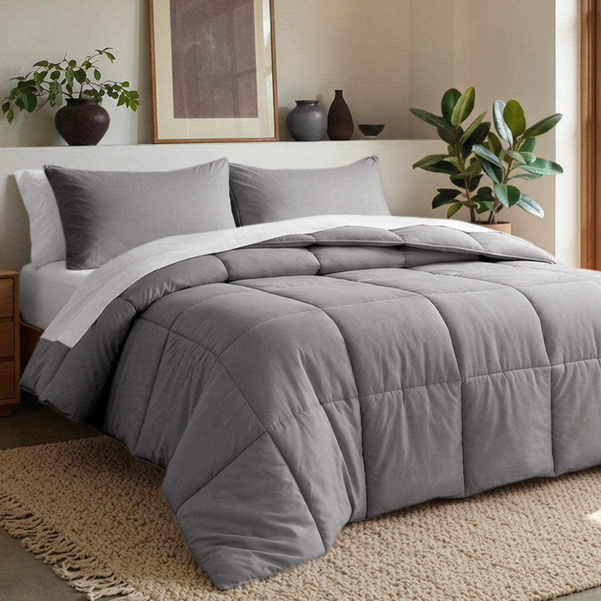 Comforter set on a bed in a bedroom with plants and decor.