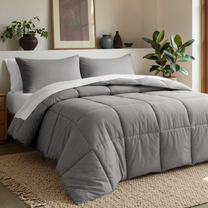 Comforter set on a bed in a bedroom with plants and decor.