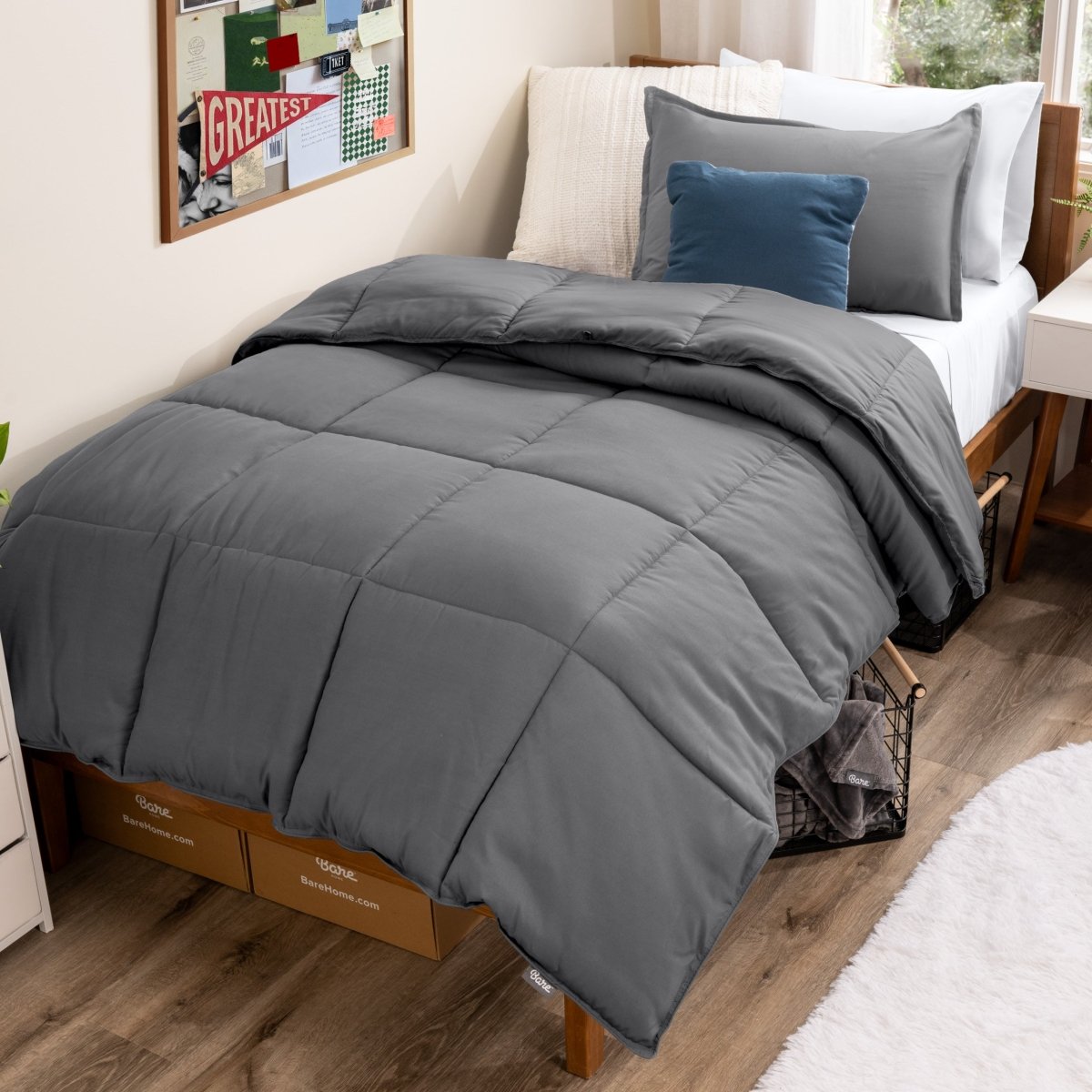Bed with comforter and pillows in a dorm room