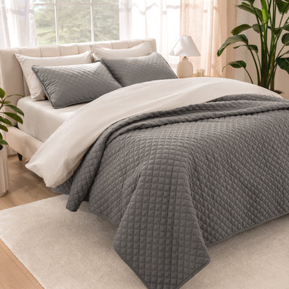 Bedroom showing coverlet set laying on the bed with the quilt folded over on itself