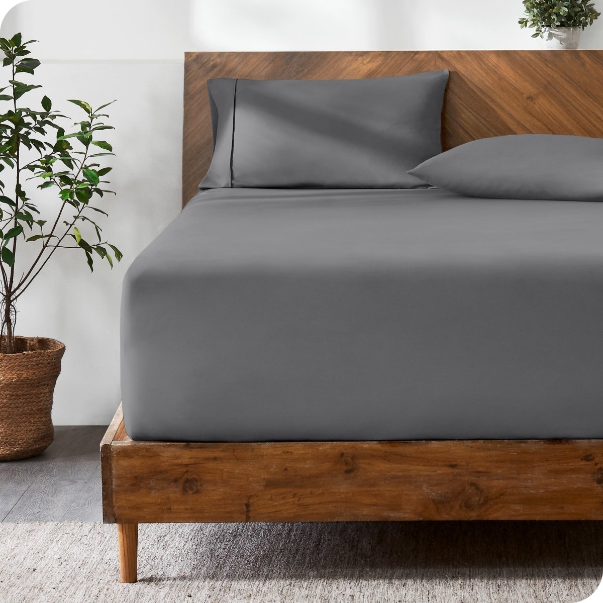 Wooden bed with ultra soft bedding in a minimalistic room.