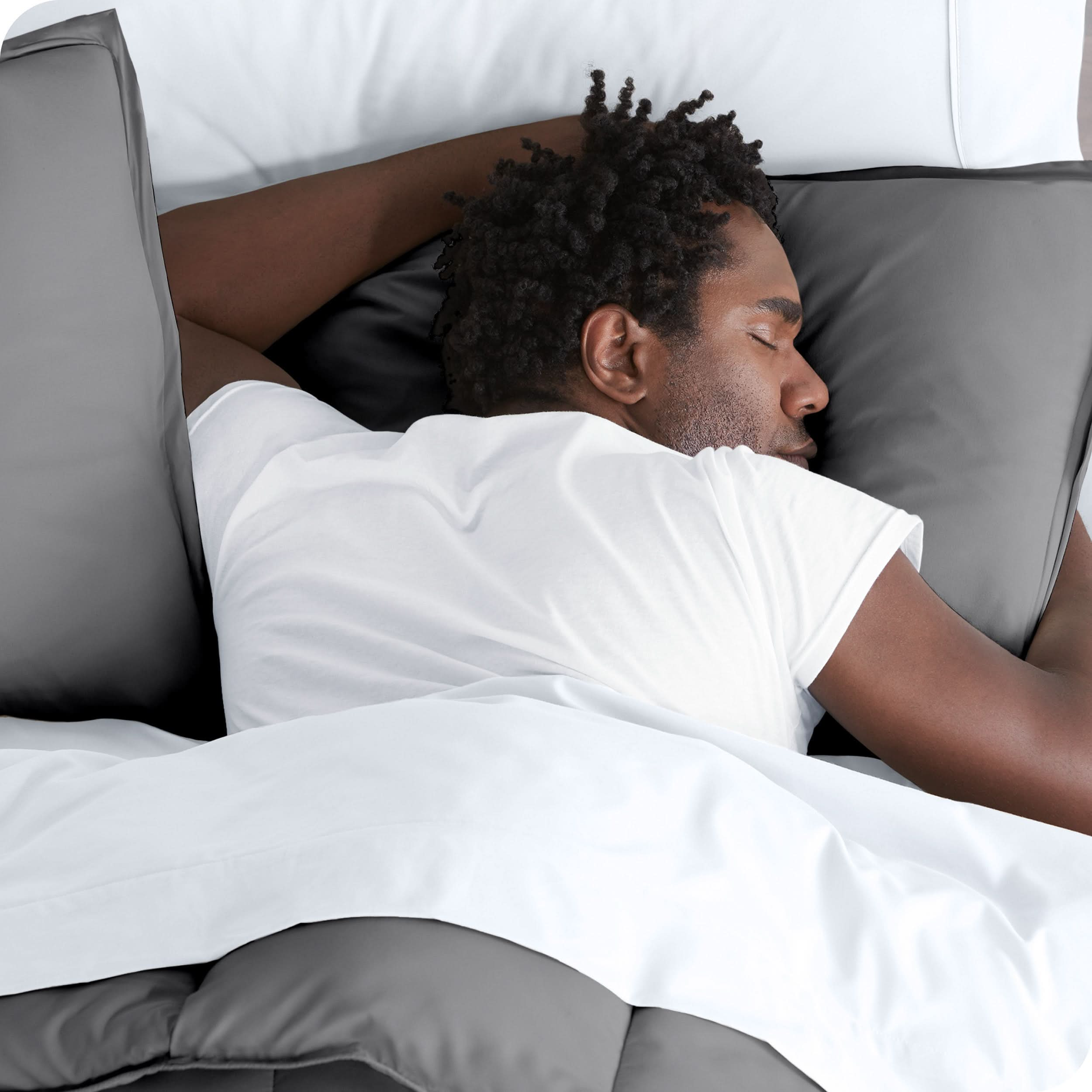 Man sleeping with his head resting on a pillow sham