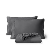 Pillowcases and a matching fitted sheet folded in front, shown on a plain white background.