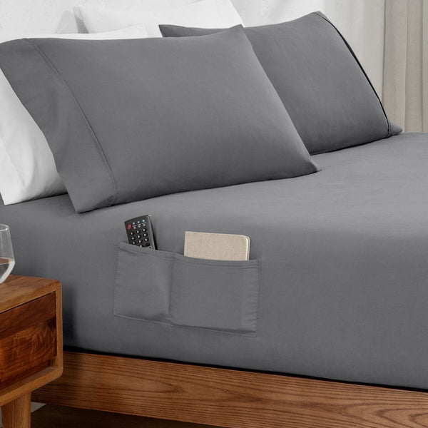 Remote control and journal in the pockets of a fitted sheet
