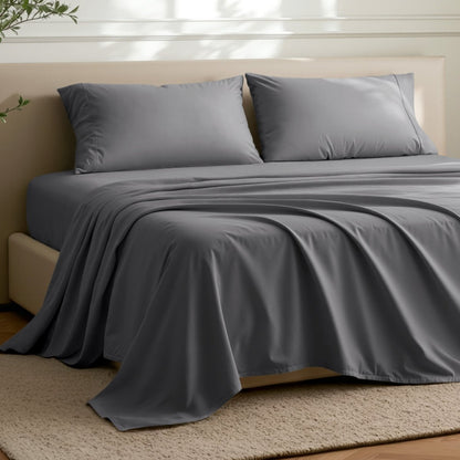 Microfiber flat sheet on a bed in a bedroom with a plant.