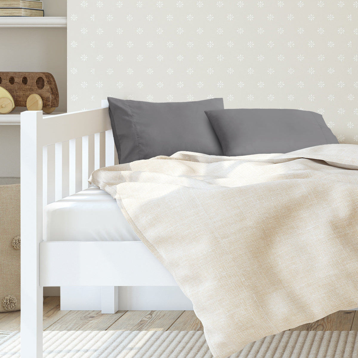 A toddler's bed with 2 microfiber pillowcases on pillows