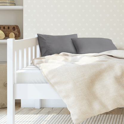 A toddler's bed with 2 microfiber pillowcases on pillows