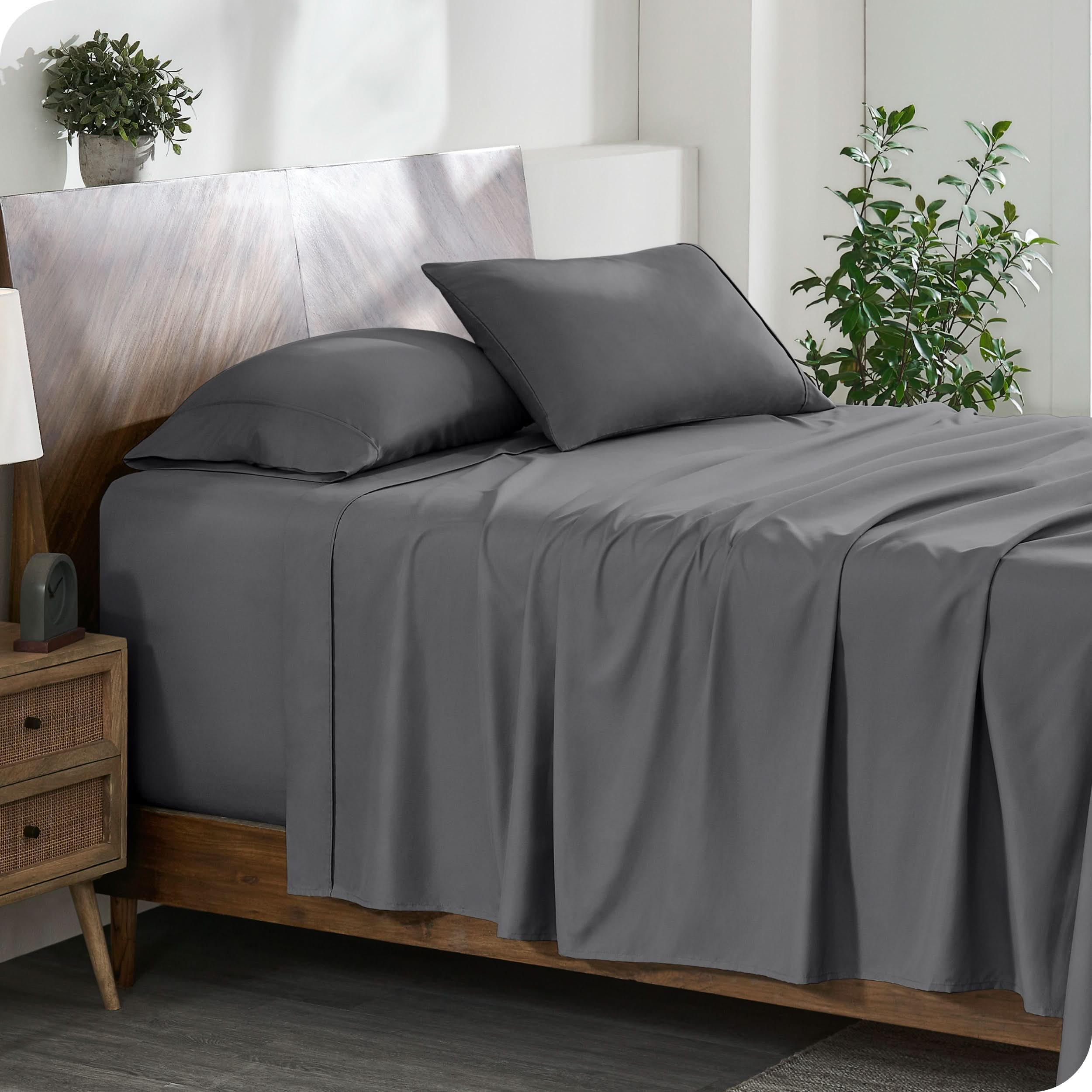 A cozy bedroom featuring a neatly made bed with soft, microfiber sheets.