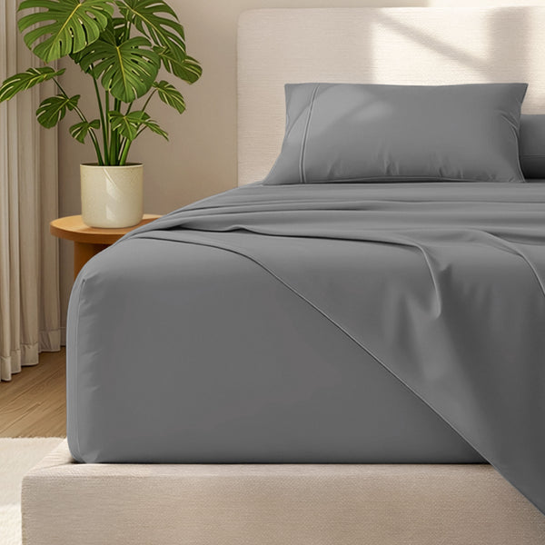 Bed with microfiber bedding and wooden headboard in a bedroom setting