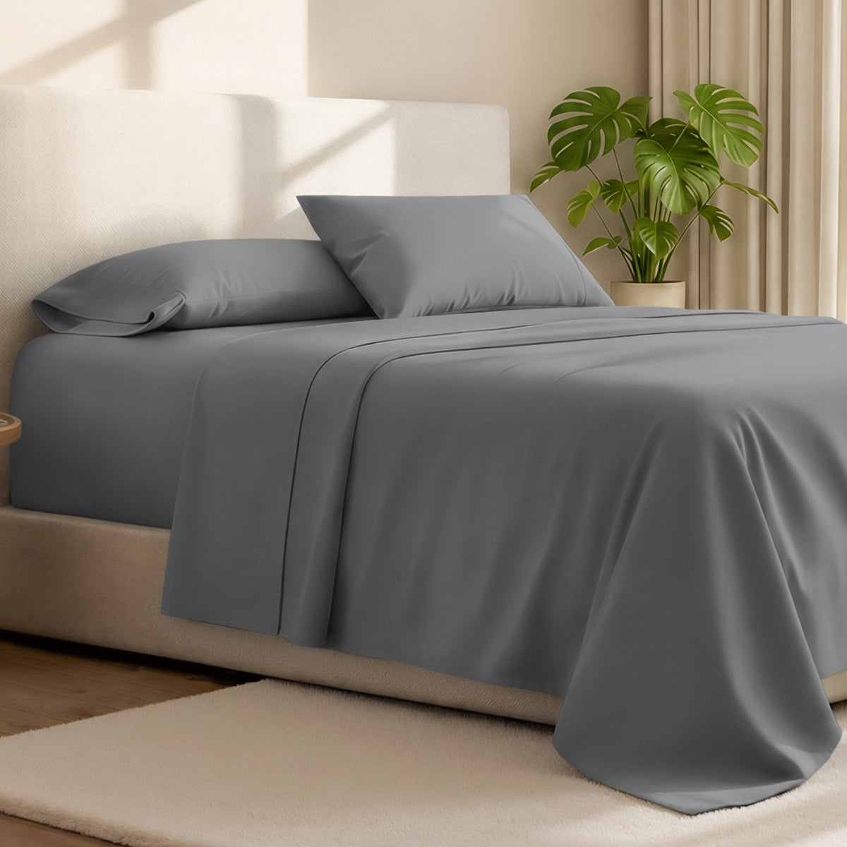 Microfiber bed sheets on a neatly made bed with a wooden headboard and nightstand.