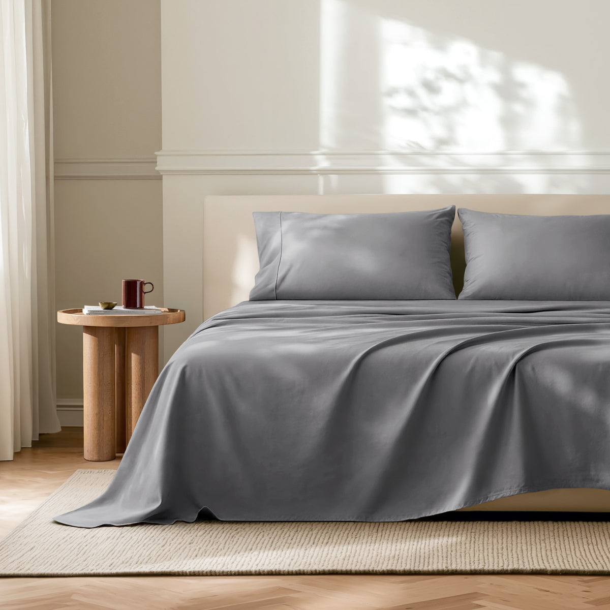 Neatly made bed with microfiber bedding in a bright bedroom.