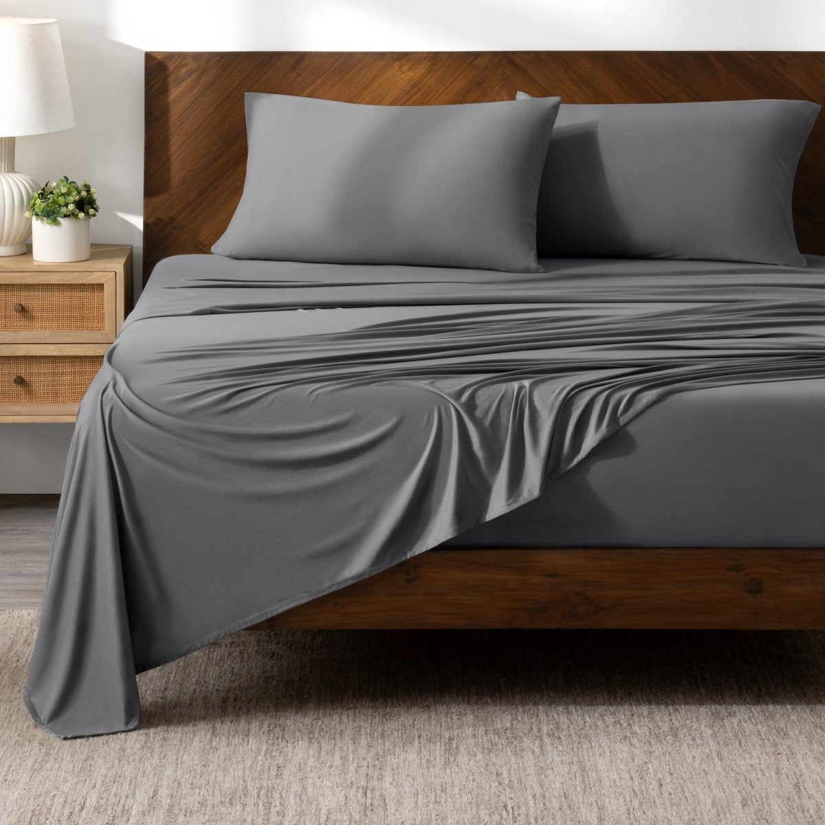 Bed sheets on a wooden bed in a bedroom setting