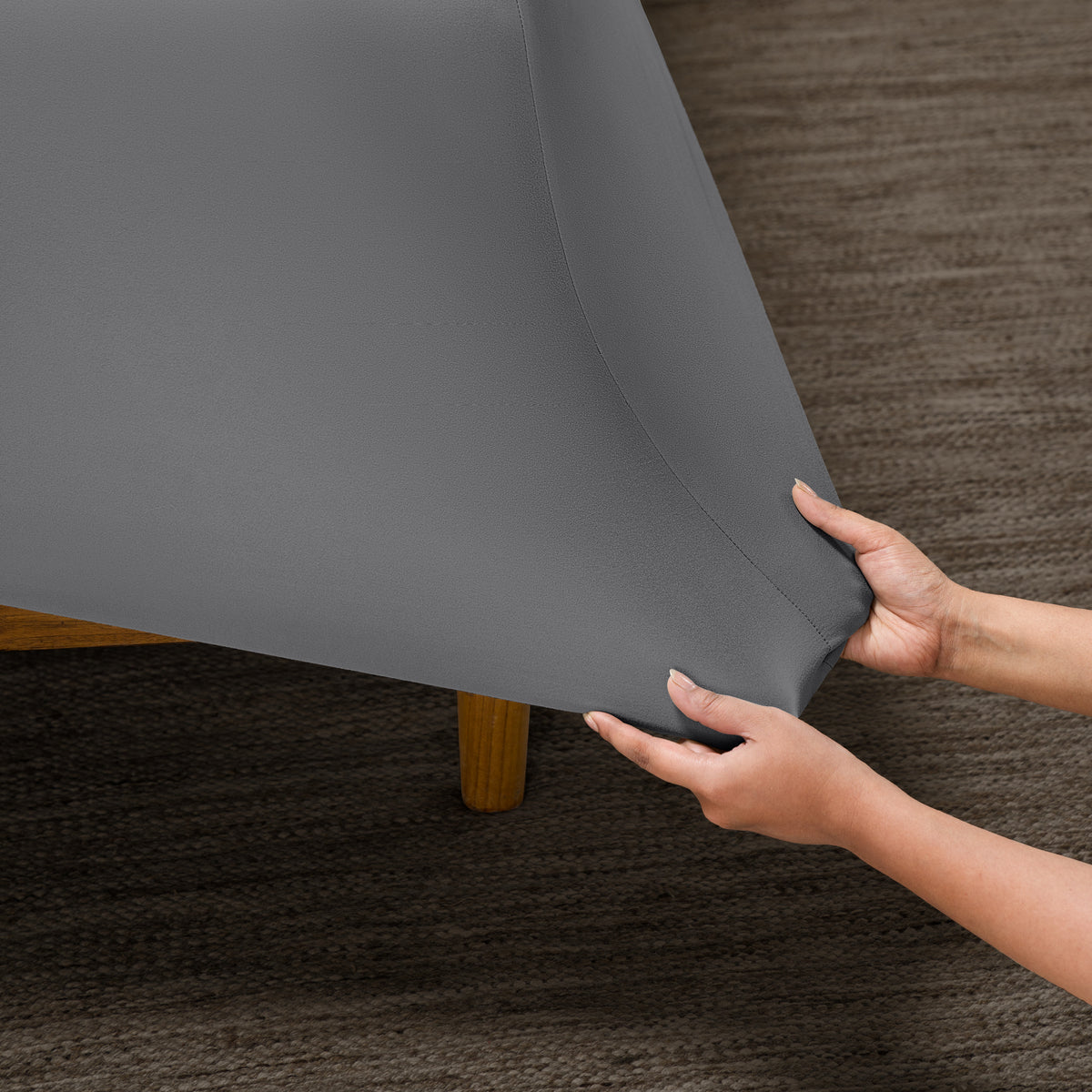 Person putting a microfiber stretch fitted sheet on a mattress