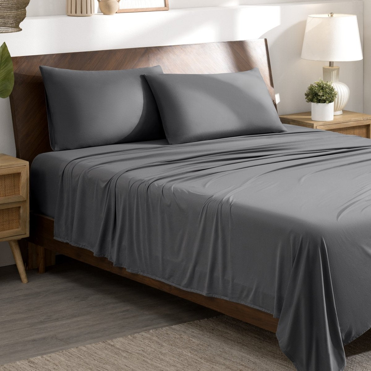 Bed sheets and pillows on a bed in a bedroom setting.