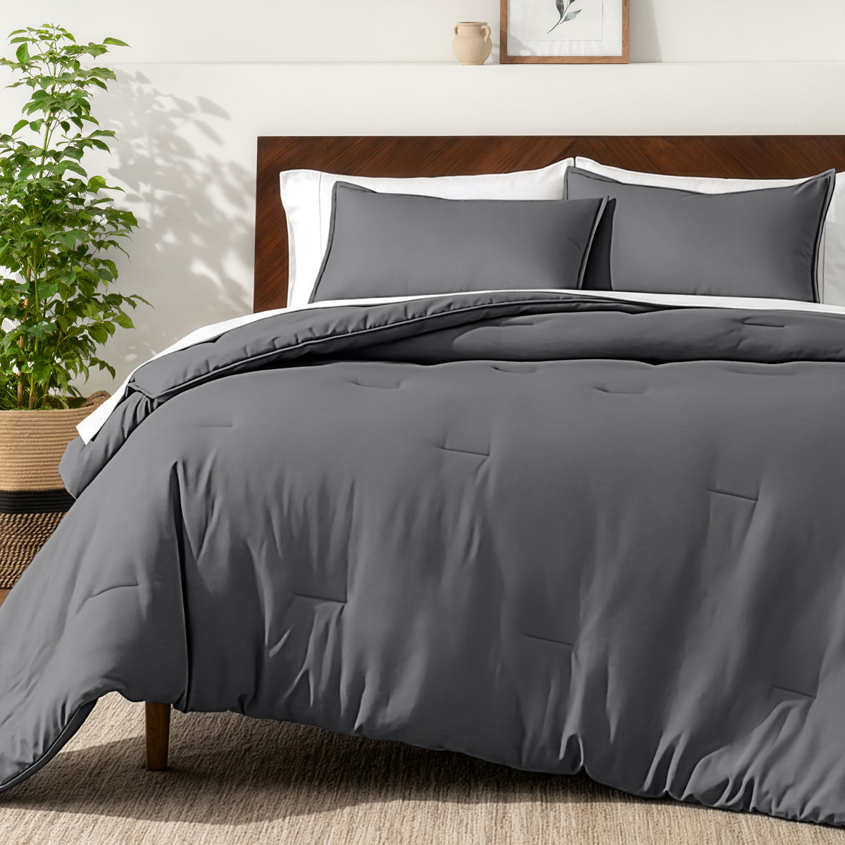 Bedding set on a bed in a bedroom with a side table and lamp.
