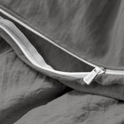 Close-up of a duvet cover with a zipper, featuring the brand Bare Home