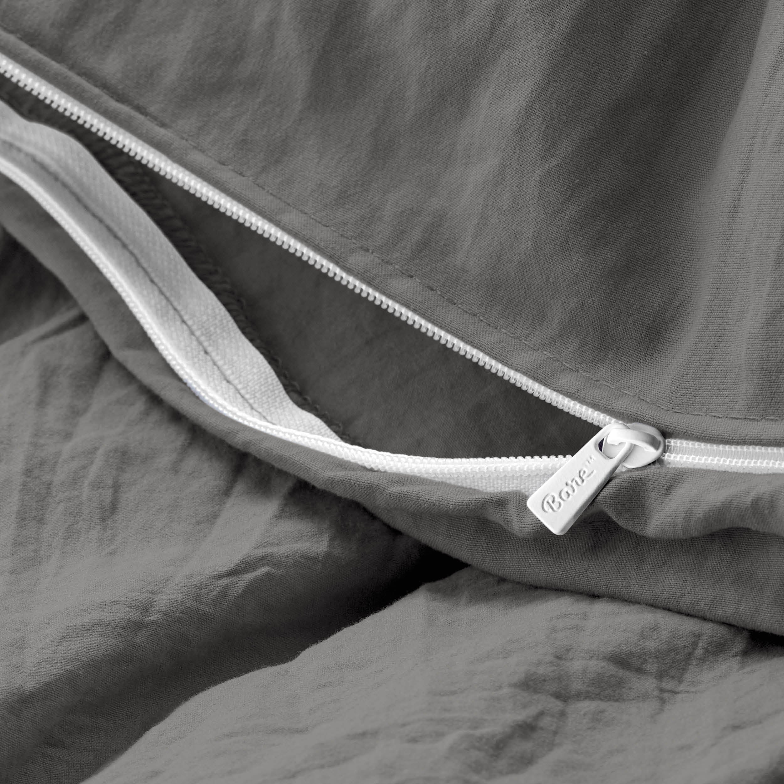 Close-up of a duvet cover with a zipper, featuring the brand Bare Home