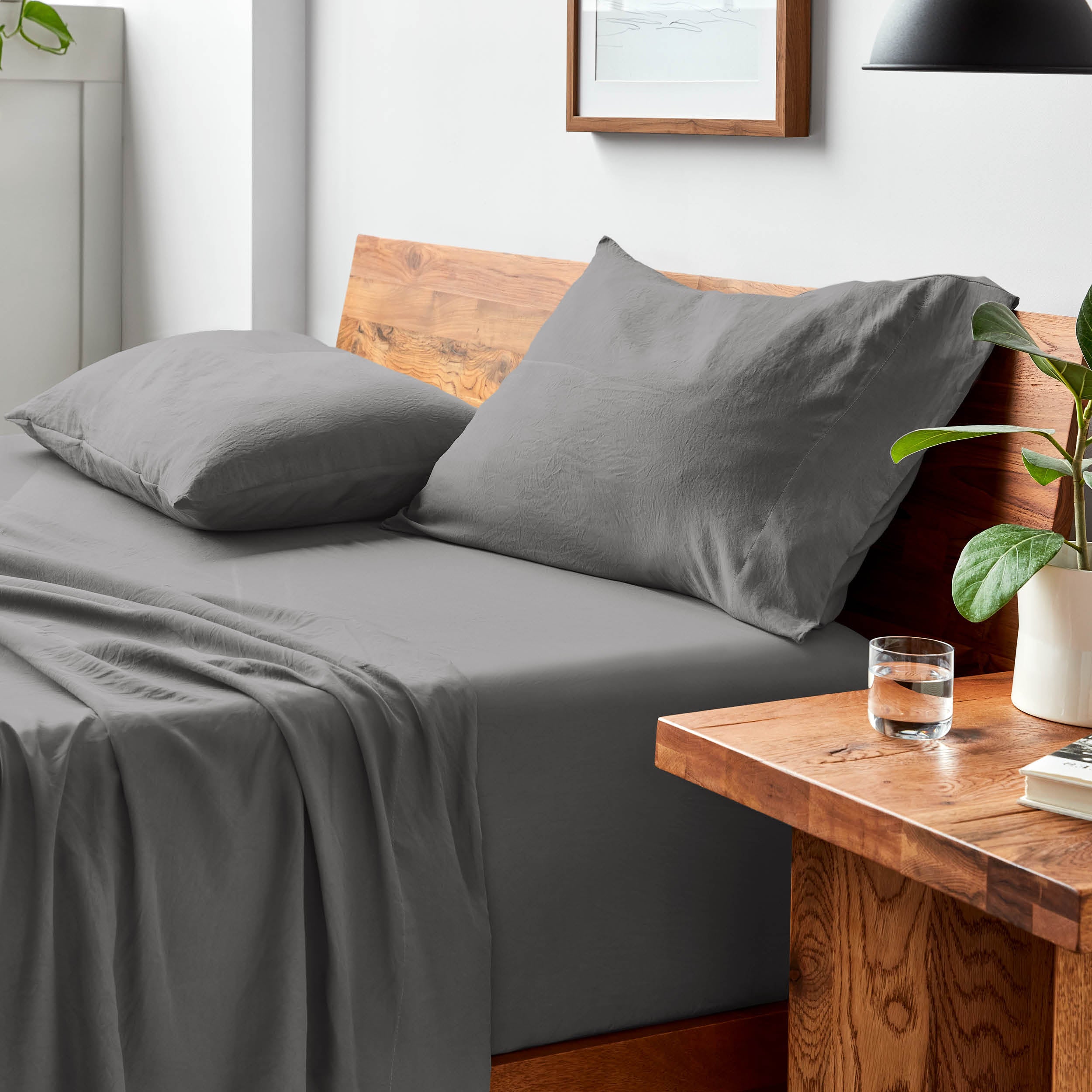 Bed with microfiber bedding and pillows in a bedroom setting