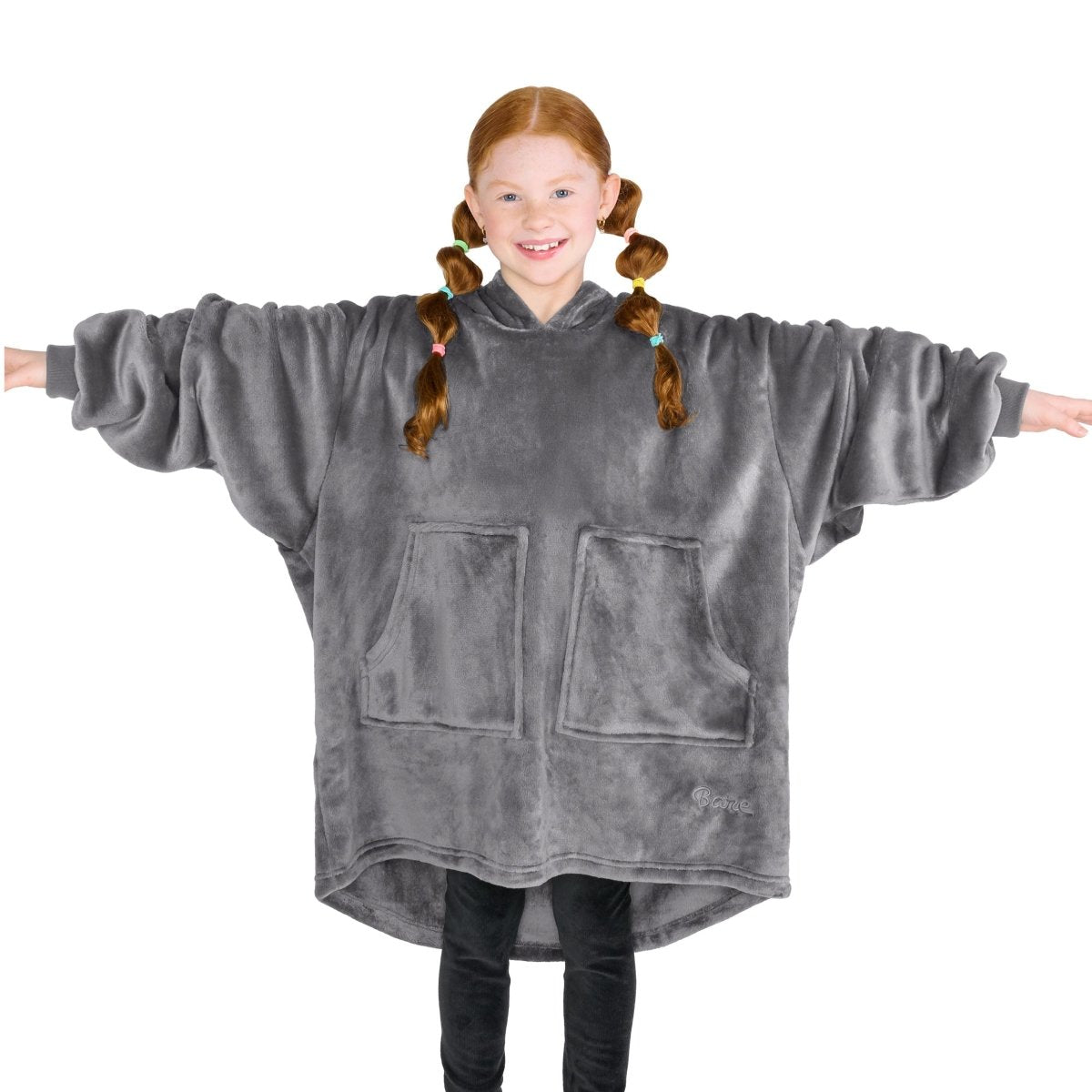 A girl is standing while wearing a microplush wearable blanket