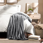Microplush blanket draped over the corner of a bed