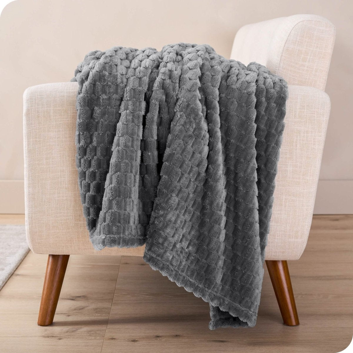 A microplush blanket draped over a chair