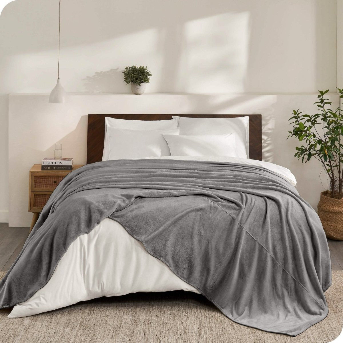 An oversized microplush blanket draped over a bed