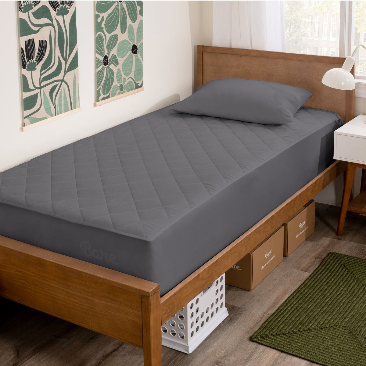 Wooden bed with grey mattress cover in a room with decorative elements.
