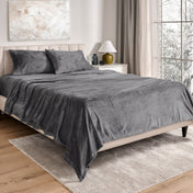 Neatly made bed in a well-lit bedroom.