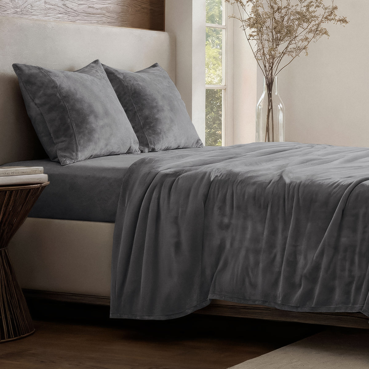Neatly made bed in a well-lit bedroom.