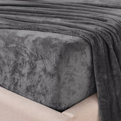 Close-up of the corner of a bed made with microplush sheets