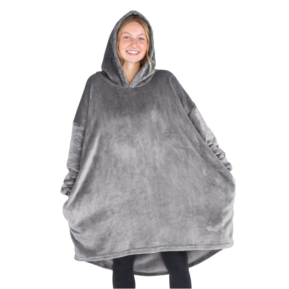 A woman wearing a cozy hooded blanket