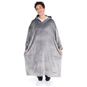 An adult is standing while wearing a long microplush wearable blanket