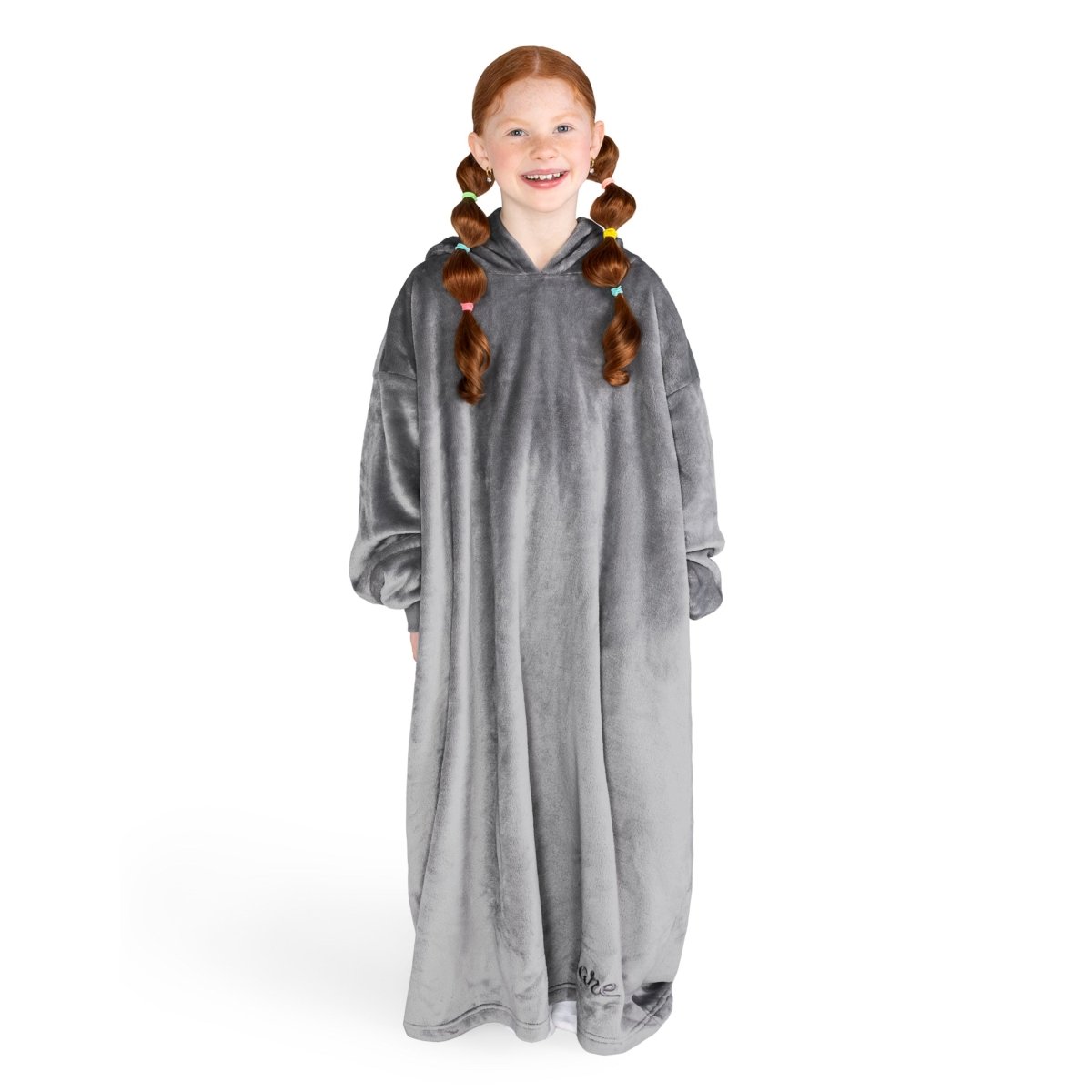 A girl is standing while wearing a long microplush wearable blanket