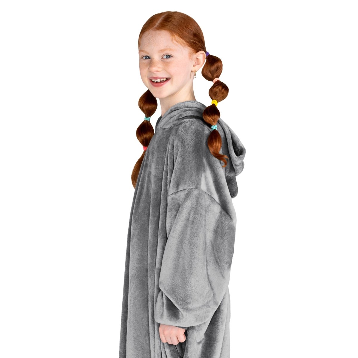 A girl has a microplush wearable blanket on