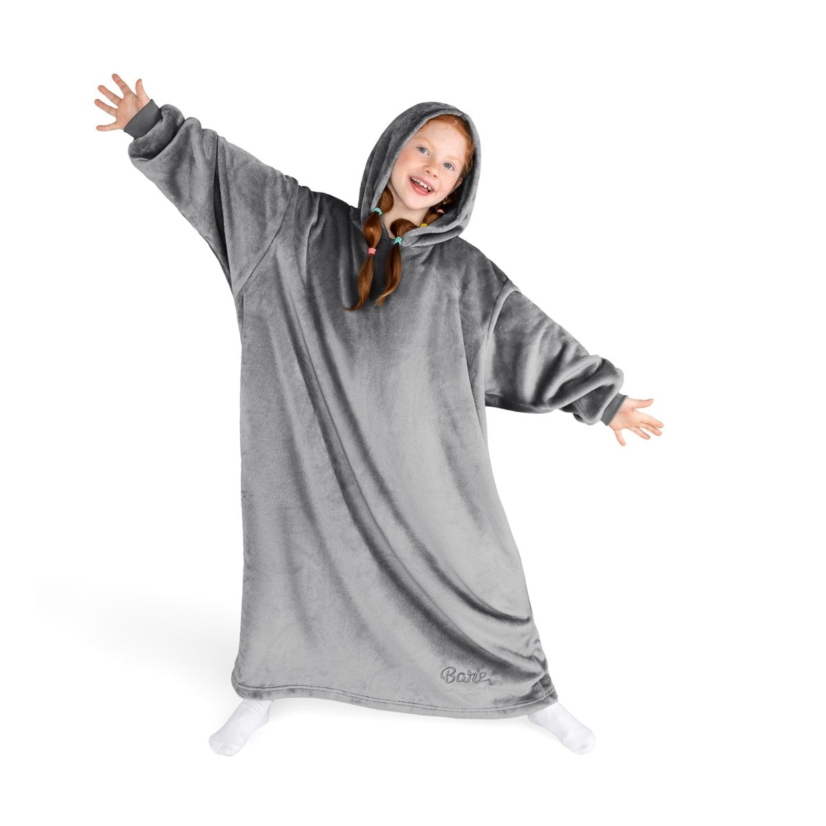 A girl has a hooded blanket on that is long enough to cover her legs