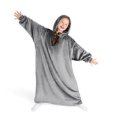 A girl has a hooded blanket on that is long enough to cover her legs