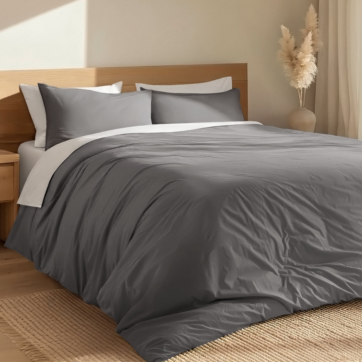 Bed with percale duvet cover set and wooden headboard in a room with a vase and decorative items.