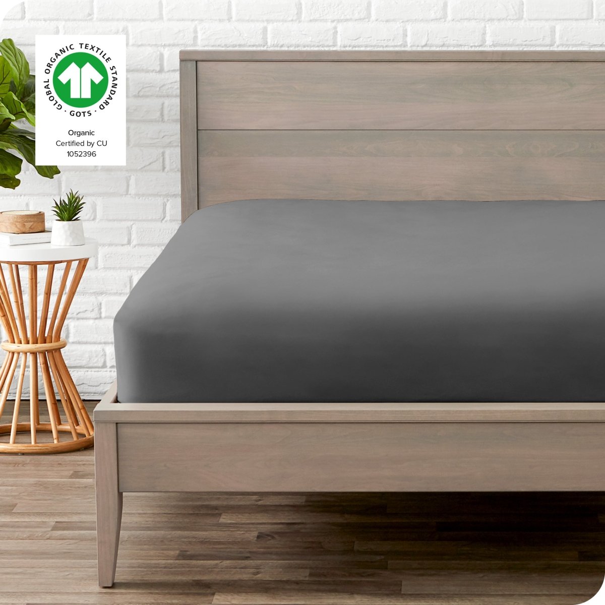 Modern wood bed frame with a sateen fitted sheet on the mattress