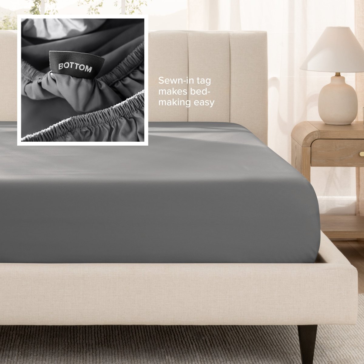 Sateen fitted sheet on a bed with a close-up of a sewn-in tag, set in a bedroom.