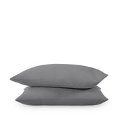 Two pillows stacked on a white background